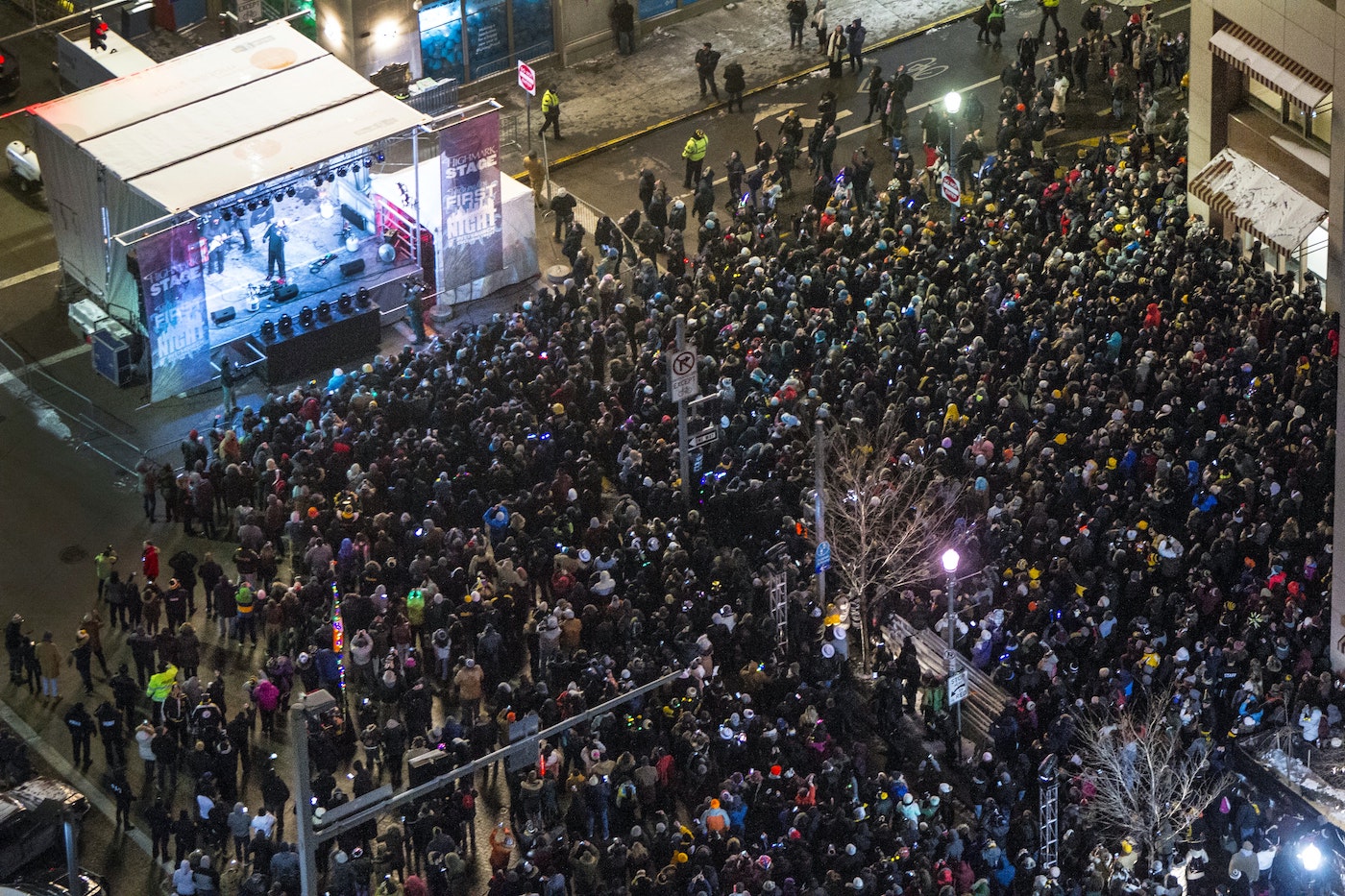 A large crowd is amassed on front of a stage