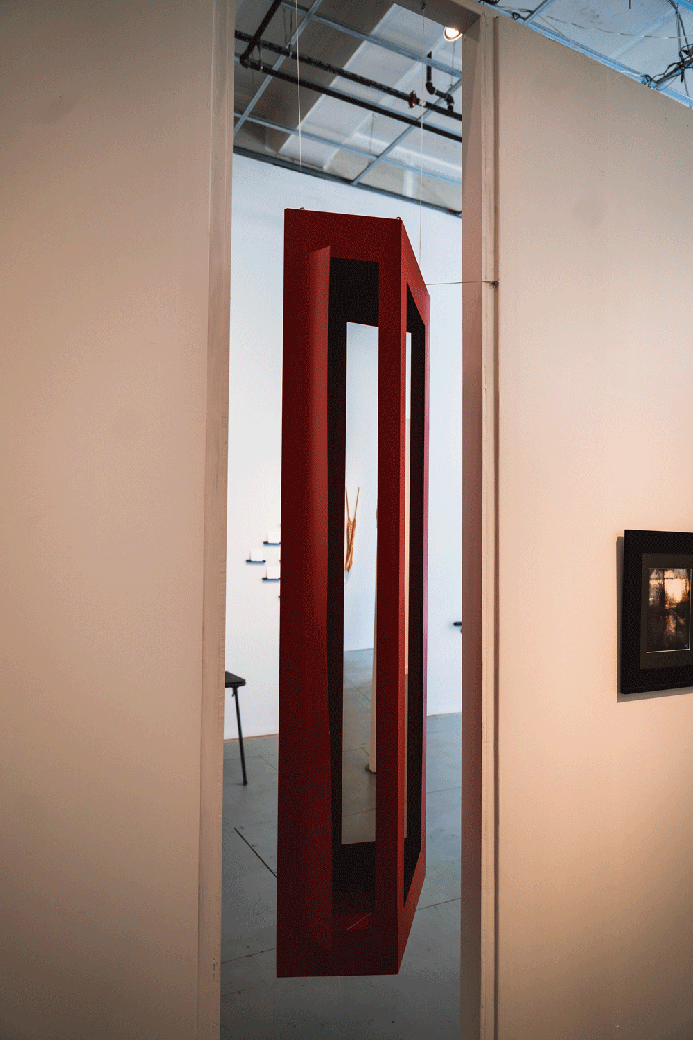 A Rectangular Sculpture Hangs In A Wall Cutout