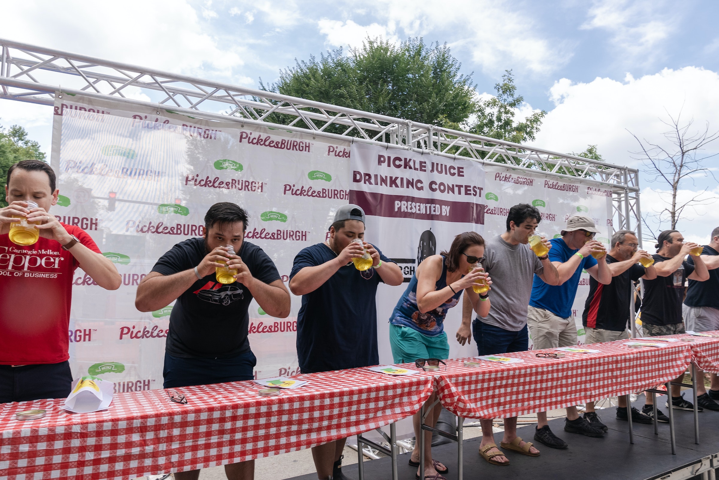 A Row Of People Drink Pickle Juice