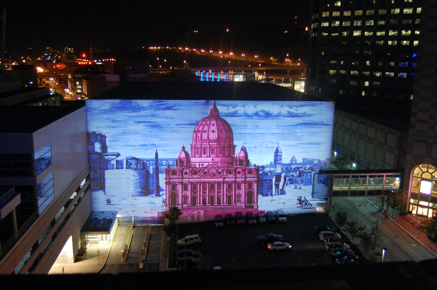 An image of a building is projected onto a city structure