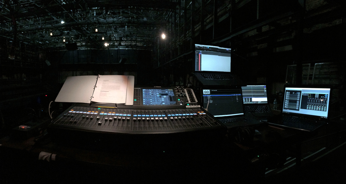 A script sits on top of a full sound board mixer