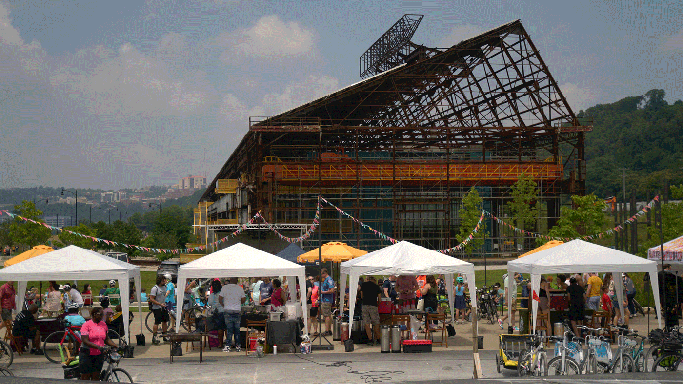 Tents Line A Sidewalk In Front Of A Large Building