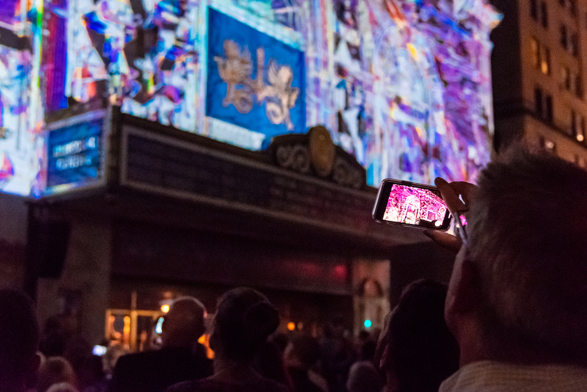 Someone takes a picture of a light projection