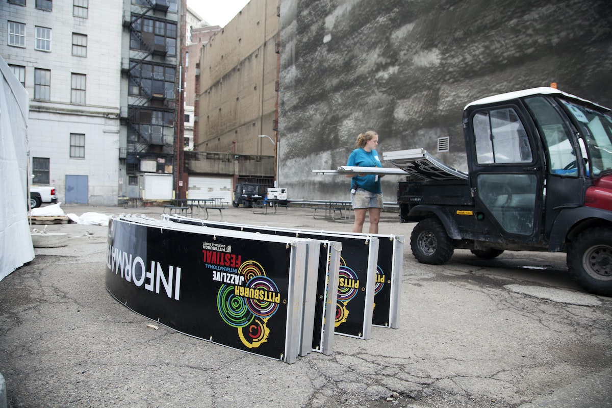 A person loads signs into the bed of a truck