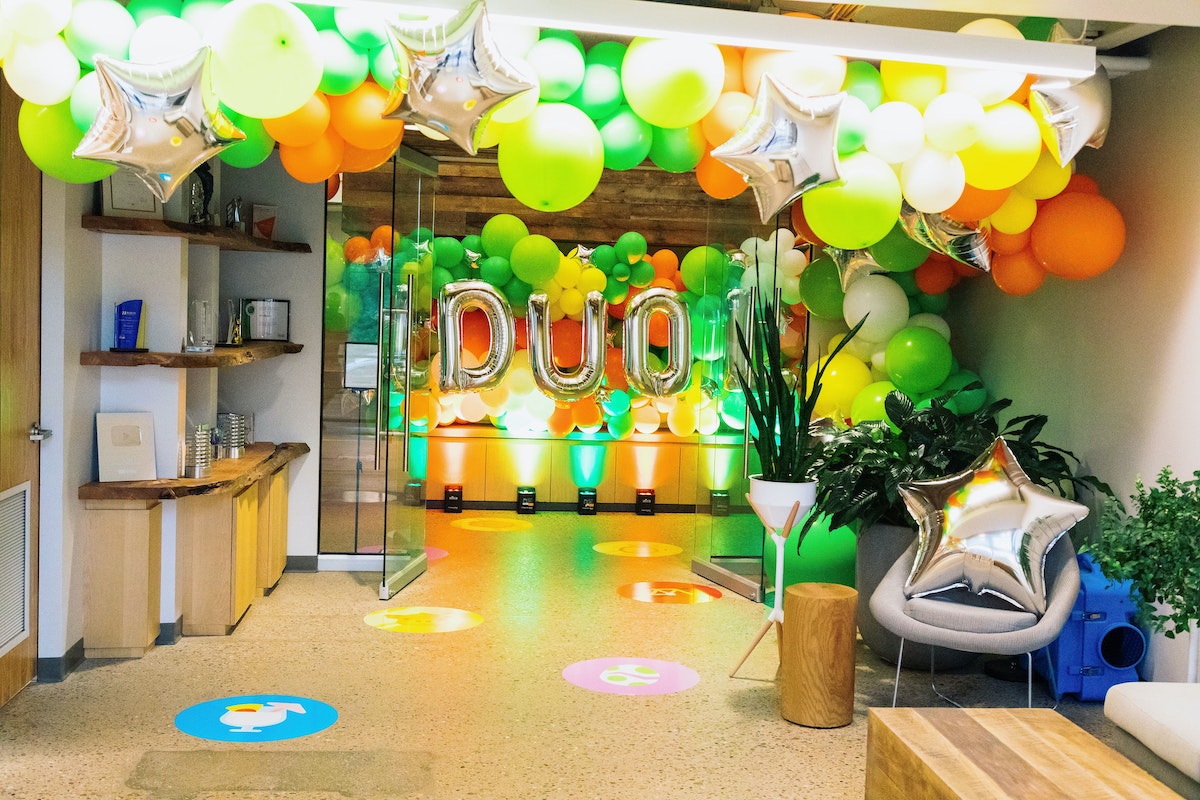 An office lobby is full of balloon arches and stars