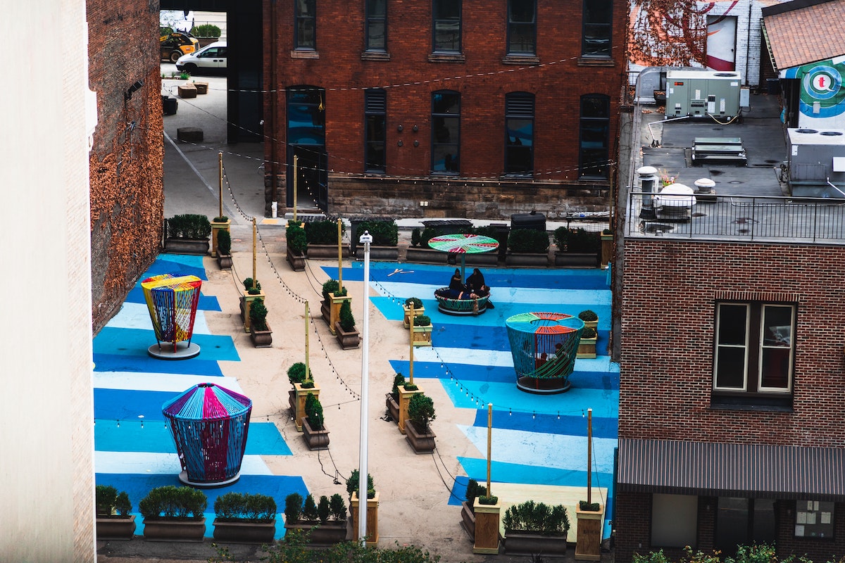 colorful seats are arranged in a blue painted lot