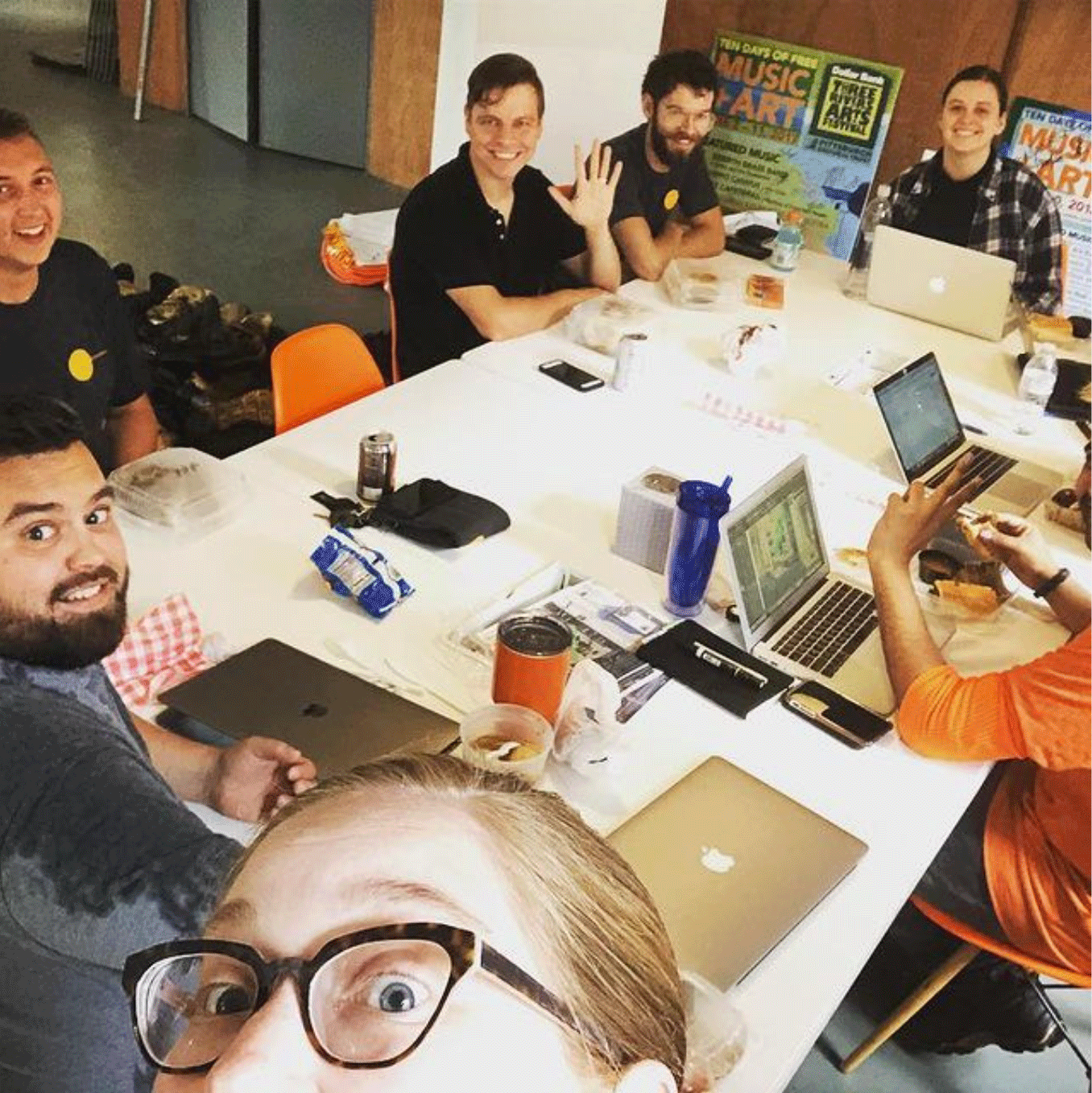 Flyspace staff around table smiling at selfie being taken