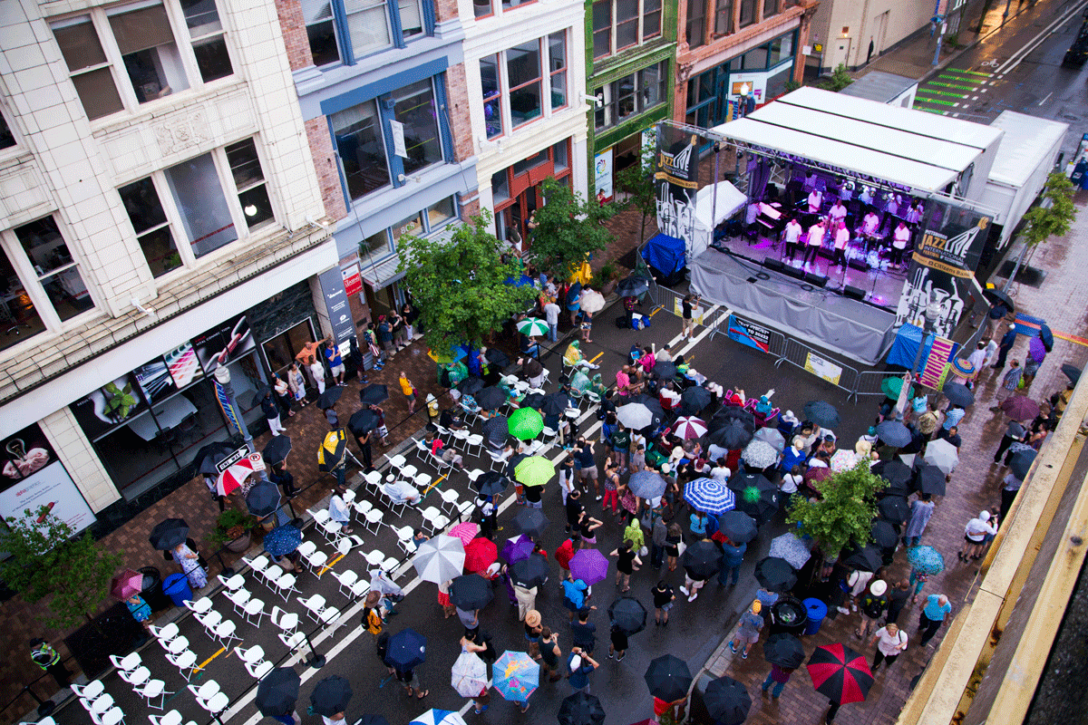 An aerial view of a crowd watching performers on a stage