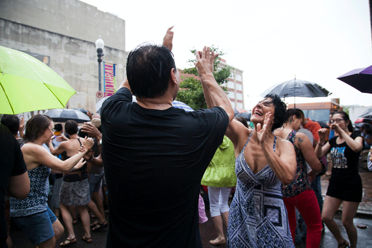 Two people dancing together in front of a crowd