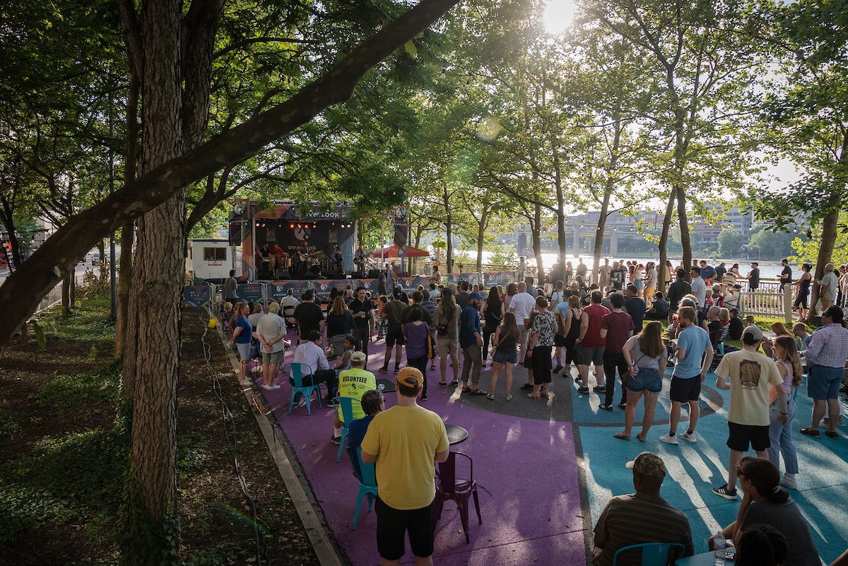 A crowd is gathered on a closed street in front of a stage